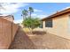 Side yard showing desert landscaping, a large shade tree and a block wall at 6436 W Wahalla Ln, Glendale, AZ 85308