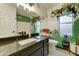 Eclectic bathroom featuring a black marble vanity and a decorative plant-themed design at 6461 E Jensen St, Mesa, AZ 85205