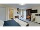 Well-lit bedroom with a full-sized bed, private bathroom, and a sliding door to the outdoors at 6461 E Jensen St, Mesa, AZ 85205