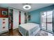 Contemporary bedroom with a built-in wardrobe, sliding doors, and vibrant wall colors at 6461 E Jensen St, Mesa, AZ 85205