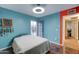 Bright bedroom with a queen bed, aqua walls, and a glass door to the outside at 6461 E Jensen St, Mesa, AZ 85205