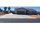 This exterior of this single Gathering home features an extended driveway and mature palm trees at 6461 E Jensen St, Mesa, AZ 85205