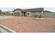 A cozy single-Gathering home featuring a two-car garage and desert landscaping at 6461 E Jensen St, Mesa, AZ 85205