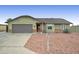 Charming single-story home featuring a two-car garage and low maintenance desert landscaping at 6461 E Jensen St, Mesa, AZ 85205