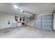 An empty garage with open door, lighting, and some items stored inside at 6461 E Jensen St, Mesa, AZ 85205