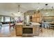 Open-concept kitchen with a central island, bar seating, and seamless flow into the living and dining areas at 6461 E Jensen St, Mesa, AZ 85205
