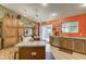 Well-lit kitchen featuring custom cabinets, granite countertops, a breakfast bar, and stainless steel appliances at 6461 E Jensen St, Mesa, AZ 85205
