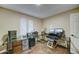 Bright office with a large glass desk, rolling chair, and a window with natural light at 6461 E Jensen St, Mesa, AZ 85205