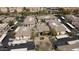 An aerial view of a charming complex with neatly arranged buildings, mature trees, covered parking, and a refreshing pool at 6900 E Princess Dr # 2124, Phoenix, AZ 85054