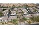 A high angle shot showcasing a residential community featuring multiple buildings, landscaping and ample parking space at 6900 E Princess Dr # 2124, Phoenix, AZ 85054