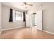 Bedroom featuring natural light, a ceiling fan, wood floors, and double doors to a patio at 6900 E Princess Dr # 2124, Phoenix, AZ 85054