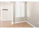 Bright bedroom with laminate flooring, large window, and neutral paint at 6900 E Princess Dr # 2124, Phoenix, AZ 85054
