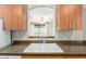 A view through the kitchen pass-through reveals a sink, faucet, and cabinets, providing a glimpse into the open living space at 6900 E Princess Dr # 2124, Phoenix, AZ 85054