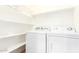 Clean laundry room with shelves and side-by-side machines at 6900 E Princess Dr # 2124, Phoenix, AZ 85054