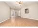 Open-concept living area with wood-look flooring, ceiling fan, and easy access to the kitchen at 6900 E Princess Dr # 2124, Phoenix, AZ 85054