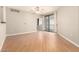 Spacious living room with laminate flooring, ceiling fan, and sliding glass doors to the balcony at 6900 E Princess Dr # 2124, Phoenix, AZ 85054