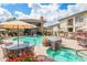 Community pool area with lounge chairs and umbrellas at 6900 E Princess Dr # 2124, Phoenix, AZ 85054