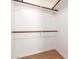 Walk-in closet featuring wood floors and rod shelving at 6900 E Princess Dr # 2124, Phoenix, AZ 85054