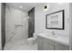 Modern bathroom features marble shower, tile floors, and contemporary vanity at 7009 E Pasadena Ave, Paradise Valley, AZ 85253
