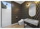 Chic powder room with patterned wallpaper, modern fixtures, and sleek sink at 7009 E Pasadena Ave, Paradise Valley, AZ 85253