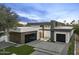Modern home exterior with sleek lines, black garage doors, and well-manicured landscaping at 7009 E Pasadena Ave, Paradise Valley, AZ 85253