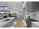 Modern kitchen with an island and barstool seating, flows into the dining and living areas at 7009 E Pasadena Ave, Paradise Valley, AZ 85253