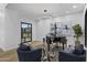 This living room boasts a modern chandelier, armchairs, and a black grand piano at 7009 E Pasadena Ave, Paradise Valley, AZ 85253