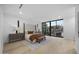 Bright main bedroom boasts hardwood floors, king bed and large sliding doors to back yard at 7009 E Pasadena Ave, Paradise Valley, AZ 85253