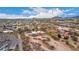 Scenic aerial view features a desert home on a large lot surrounded by green trees, and neighborhood homes in the distance at 706 N Signal Butte Rd, Mesa, AZ 85207