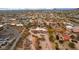 Aerial view of a desert home with a circular driveway, mature landscaping, and a neighboring community at 706 N Signal Butte Rd, Mesa, AZ 85207
