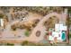 Expansive aerial view of desert home with circular driveway, pool and several patios in a quiet neighborhood at 706 N Signal Butte Rd, Mesa, AZ 85207