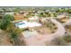 Aerial view of desert home with pool, patio and unique circular driveway in a quiet neighborhood at 706 N Signal Butte Rd, Mesa, AZ 85207