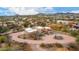 Birds eye view of a Southwestern-style home with lush landscaping and panoramic neighborhood views at 706 N Signal Butte Rd, Mesa, AZ 85207
