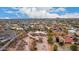 Expansive aerial view showcasing desert home on a large lot surrounded by green trees and panoramic desert landscape at 706 N Signal Butte Rd, Mesa, AZ 85207