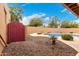 Backyard showcasing landscaped rock garden and pool at 706 N Signal Butte Rd, Mesa, AZ 85207