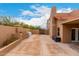 Backyard view featuring paved area, privacy wall, and tasteful landscaping at 706 N Signal Butte Rd, Mesa, AZ 85207