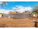 Large backyard is enclosed by a block wall, providing security and space for landscape and recreation at 706 N Signal Butte Rd, Mesa, AZ 85207