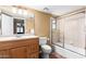 Bathroom featuring vanity, toilet, and shower-tub combo with sliding glass doors at 706 N Signal Butte Rd, Mesa, AZ 85207