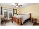 Bedroom featuring bed, ceiling fan, and direct access to the exterior at 706 N Signal Butte Rd, Mesa, AZ 85207