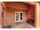 Inviting home entrance with double glass doors providing a glimpse of a well-lit interior and a tranquil atmosphere at 706 N Signal Butte Rd, Mesa, AZ 85207