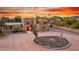 Scenic shot of a desert home with a circular driveway and a variety of cacti at 706 N Signal Butte Rd, Mesa, AZ 85207