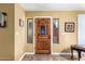 Inviting front entrance with a wood door, sidelights, and decorative tile flooring at 706 N Signal Butte Rd, Mesa, AZ 85207