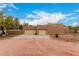 Three car garage with a desert landscape at 706 N Signal Butte Rd, Mesa, AZ 85207