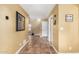 Bright hallway featuring tile flooring, neutral paint, and access to various rooms at 706 N Signal Butte Rd, Mesa, AZ 85207