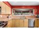 Kitchen featuring stainless appliances, wood cabinets, and granite countertops at 706 N Signal Butte Rd, Mesa, AZ 85207