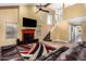 Bright living room with red fireplace, high ceilings, and large tile floors at 706 N Signal Butte Rd, Mesa, AZ 85207