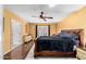 Main bedroom has hardwood flooring, ceiling fan, and an exterior door to the backyard at 706 N Signal Butte Rd, Mesa, AZ 85207