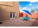 Outdoor patio with dining table and chairs, a charming gate and blue accents at 706 N Signal Butte Rd, Mesa, AZ 85207