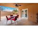 Cozy covered patio with table, seating, and outdoor fireplace at 706 N Signal Butte Rd, Mesa, AZ 85207