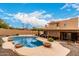 Beautiful pool area with desert landscaping and inviting outdoor lounge at 706 N Signal Butte Rd, Mesa, AZ 85207